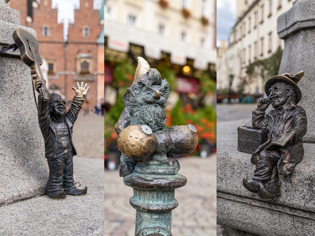 Mehrere Breslauer Zwerge in der Altstadt, darunter ein Gitarrist, ein Musiker und ein lesender Zwerg auf einer Bank