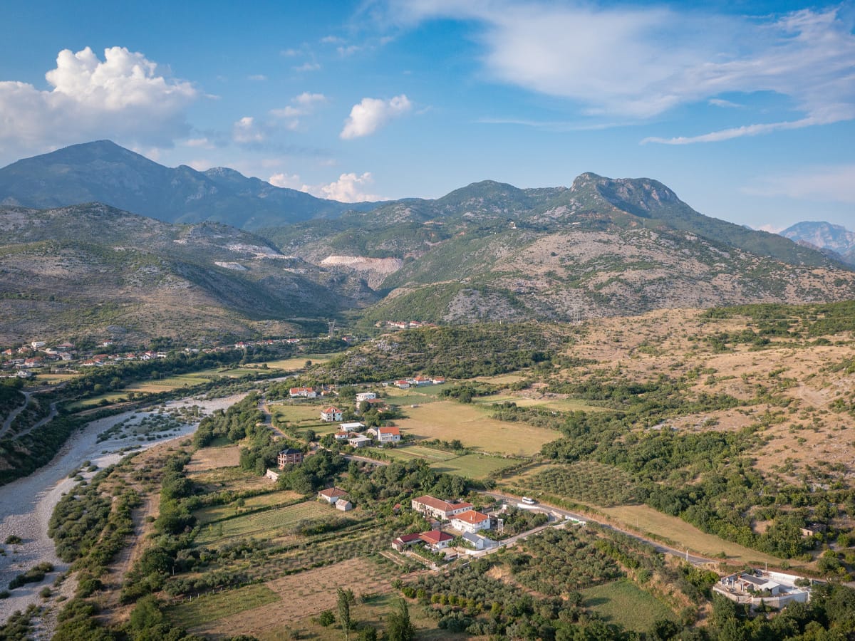 Landschaft von Postribë bei Shkodra mit dem Kir-Fluss und den Bergen Nordalbaniens aus der Drohnenperspektive