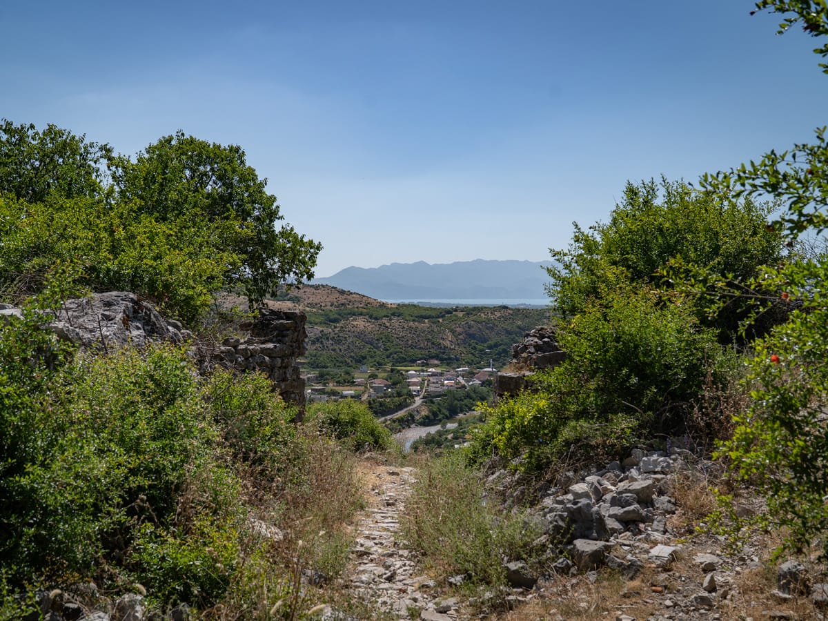 Schmaler Pfad zur inneren Burg von Drisht in Albanien mit Abzweig zum unmarkierten Trampelpfad.